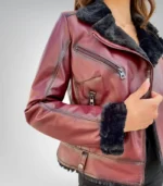 Woman wearing a furry burgundy genuine leather jacket with fur collar