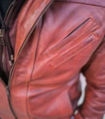Detailed shot of pocket and zipper on men’s tan lambskin hooded bomber jacket